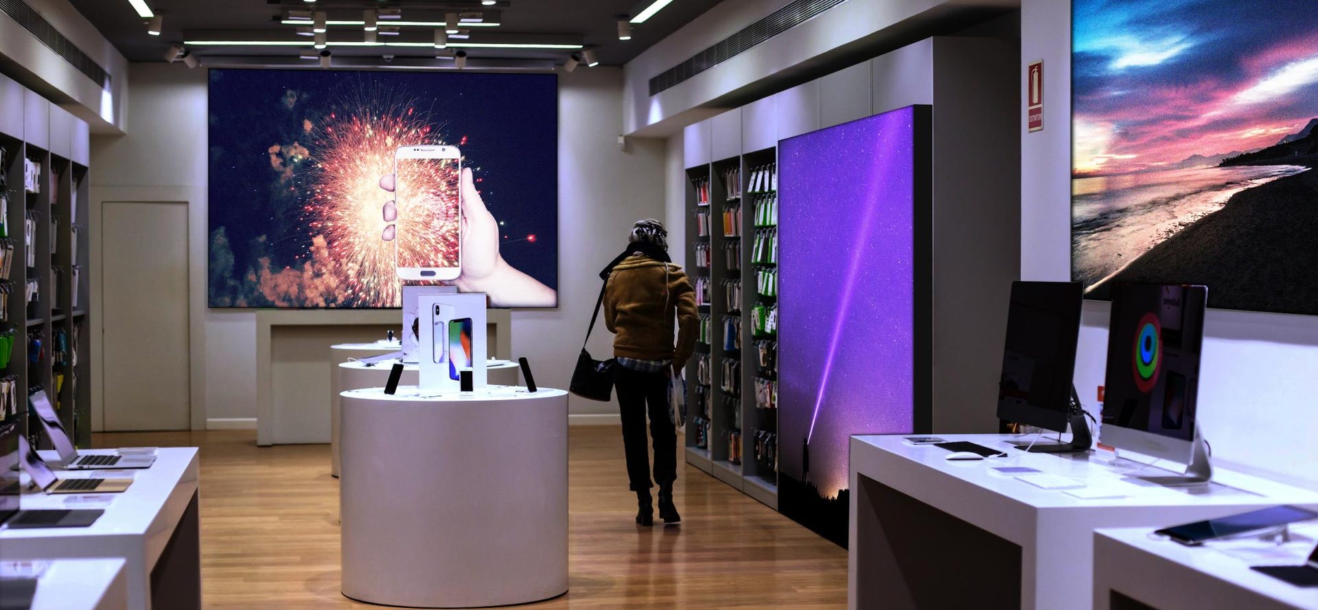 Multiple illuminated SEG walls in an electronics retail interior