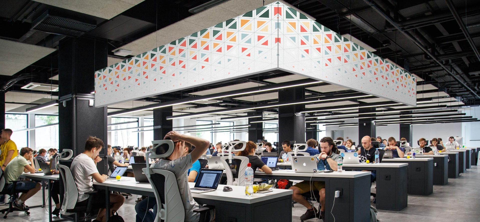 Suspended lightbox graphic over an open office