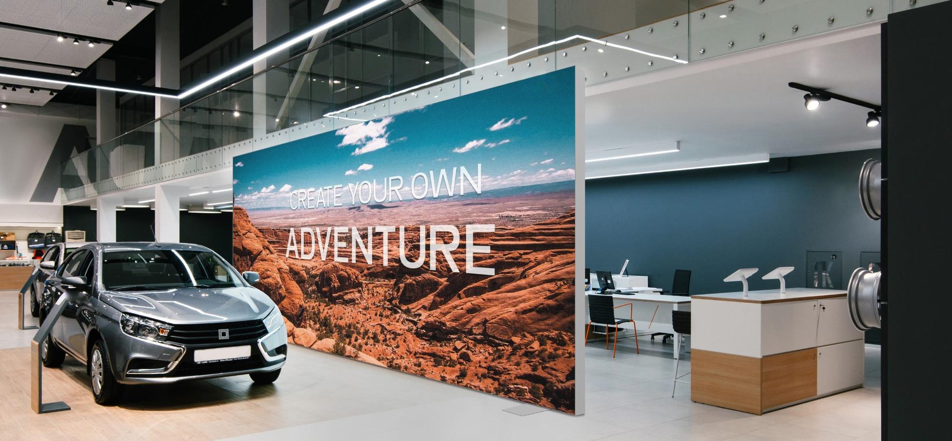 Large illuminated textile wall in an auto showroom